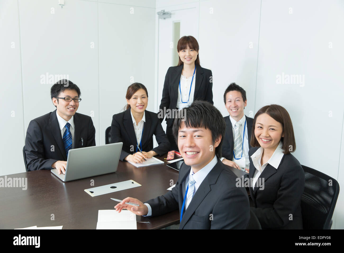 Business People in Meeting and Looking at Camera Stock Photo