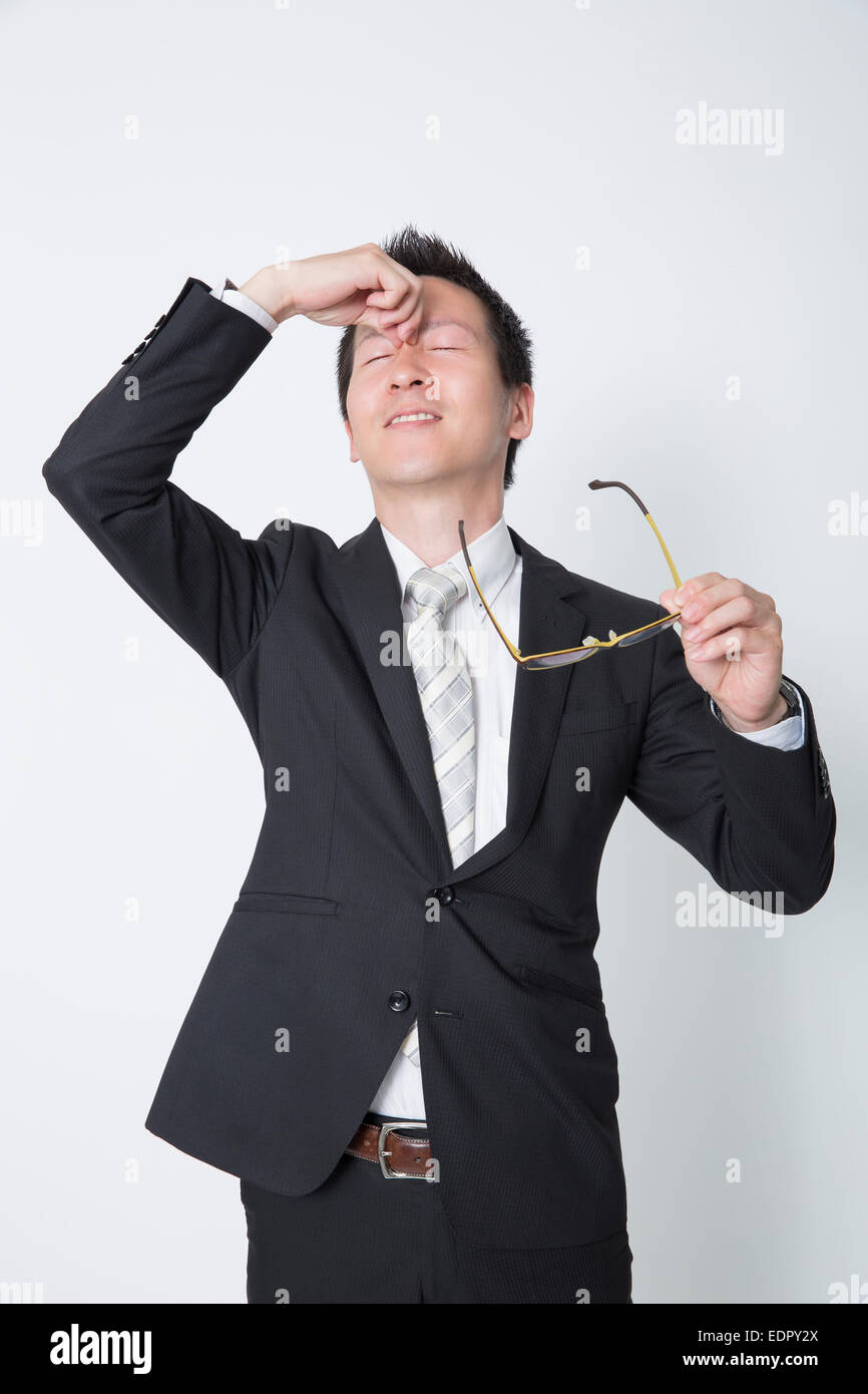 Tired Businessman Rubbing His Eyes Stock Photo