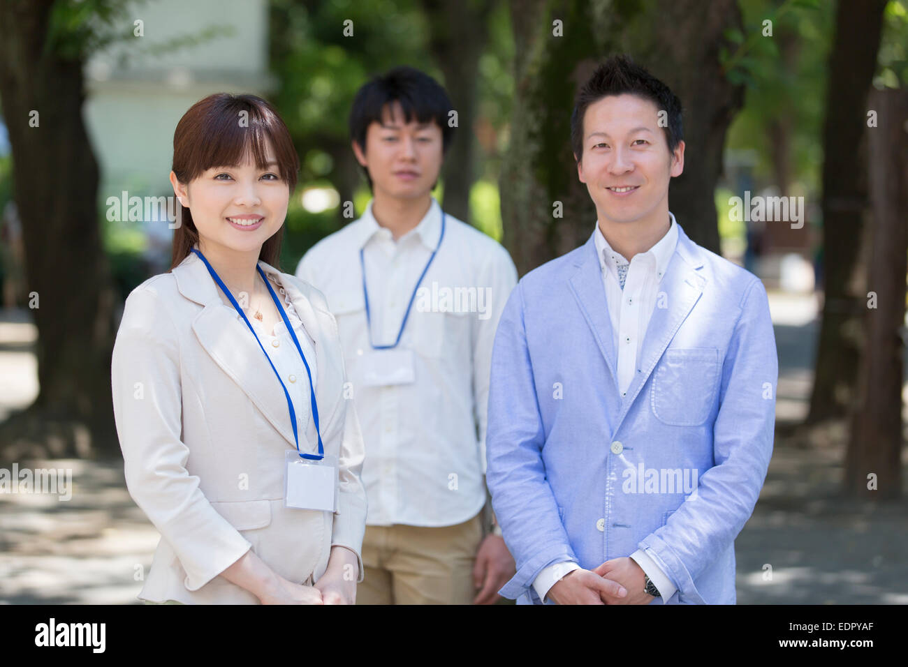 Business People Standing Side by Side And Looking at Camera Stock Photo