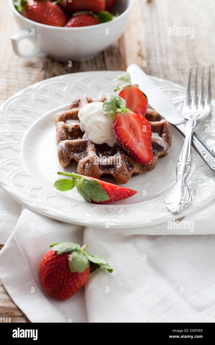 Belgian waffles with vanilla ice cream and strawberries Stock Photo - Alamy