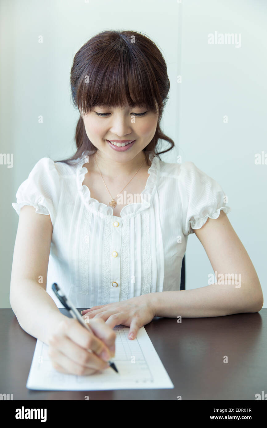 Woman Filling out Job Application Stock Photo