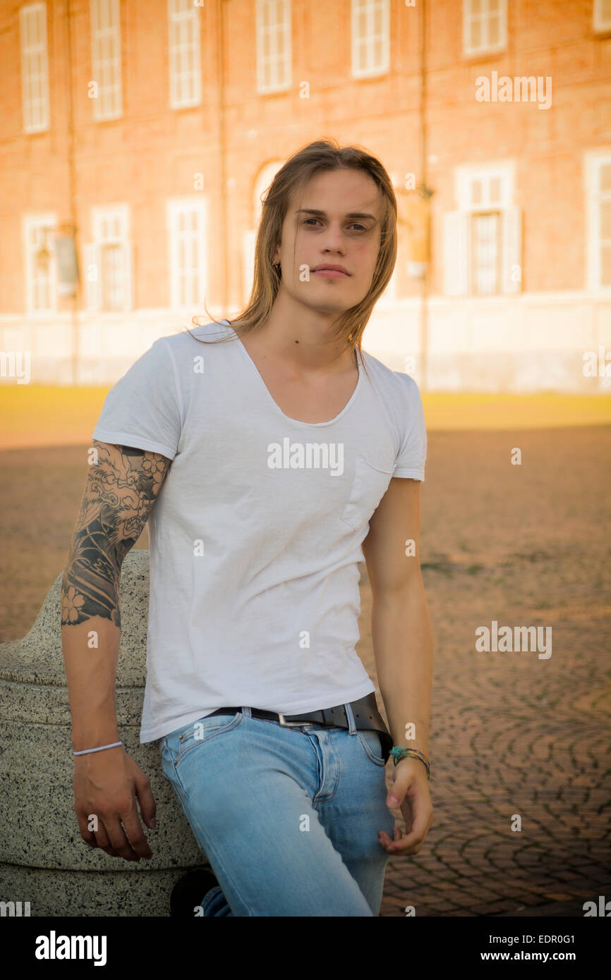 Handsome Long Hair Man on White Shirt Standing in Turin, Italy Stock Photo