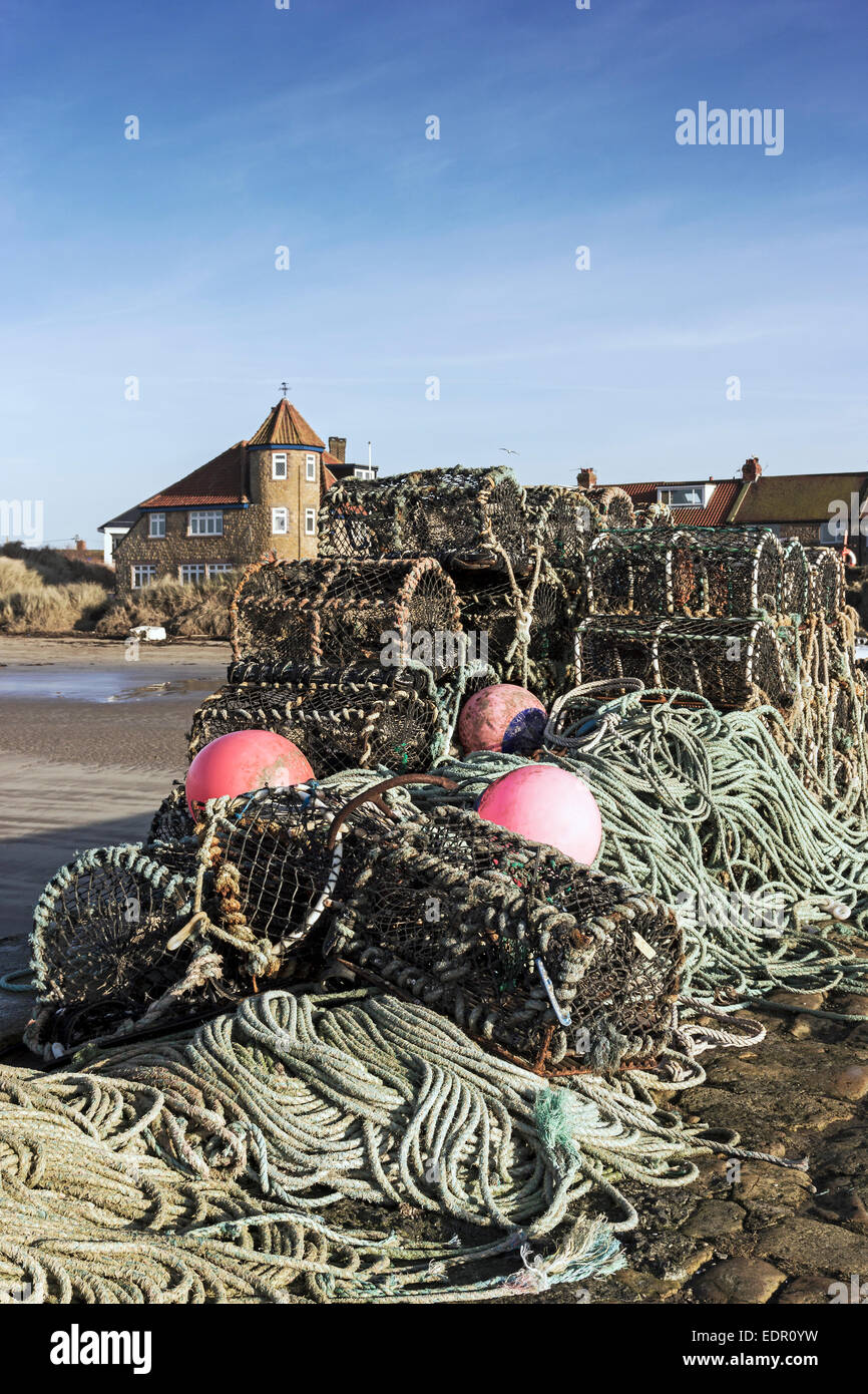 View over lobster pots in Beadnell Bay, Northumberland towards Beadnell Village Stock Photo
