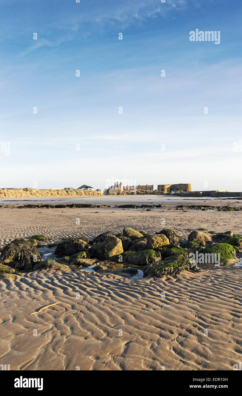 Looking from Beadnell Bay beach back towards Beadnell village and 18th century lime kilns on the Northumberland coastline, UK. Stock Photo