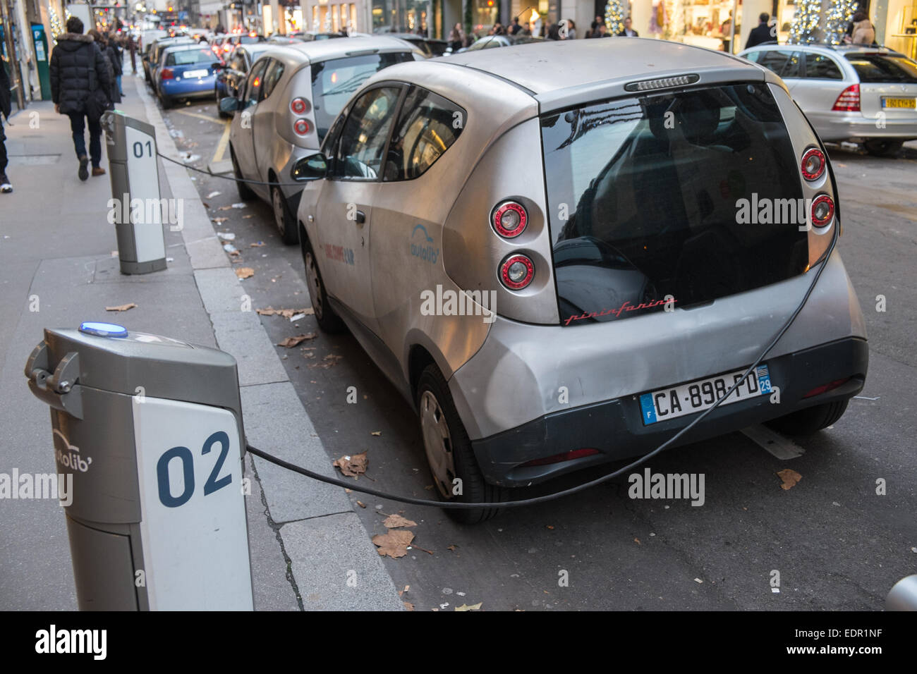 Recharging electric cars parked at charging bays along fashionable Rue