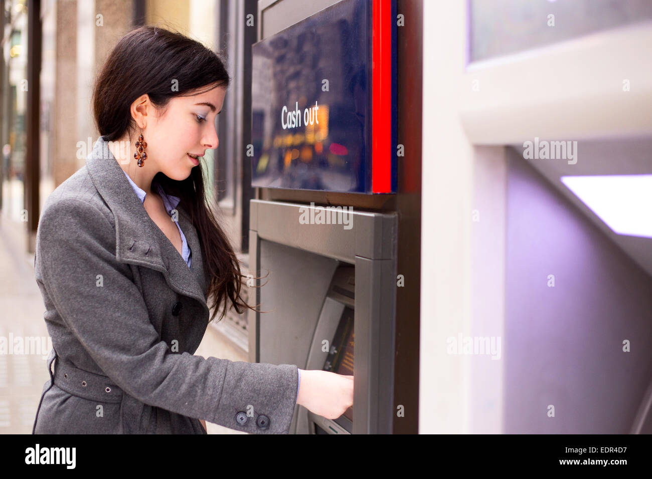 young woman withdrawing cash at the atm. Stock Photo