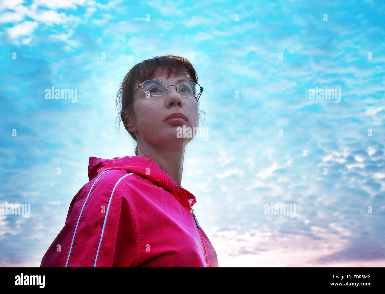 Portrait of young woman at glasses against  sunset Stock Photo