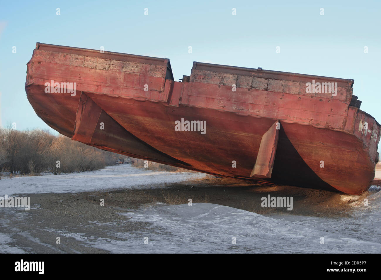 huge barge stranded at beach awaiting shipment of scrap metal Stock Photo