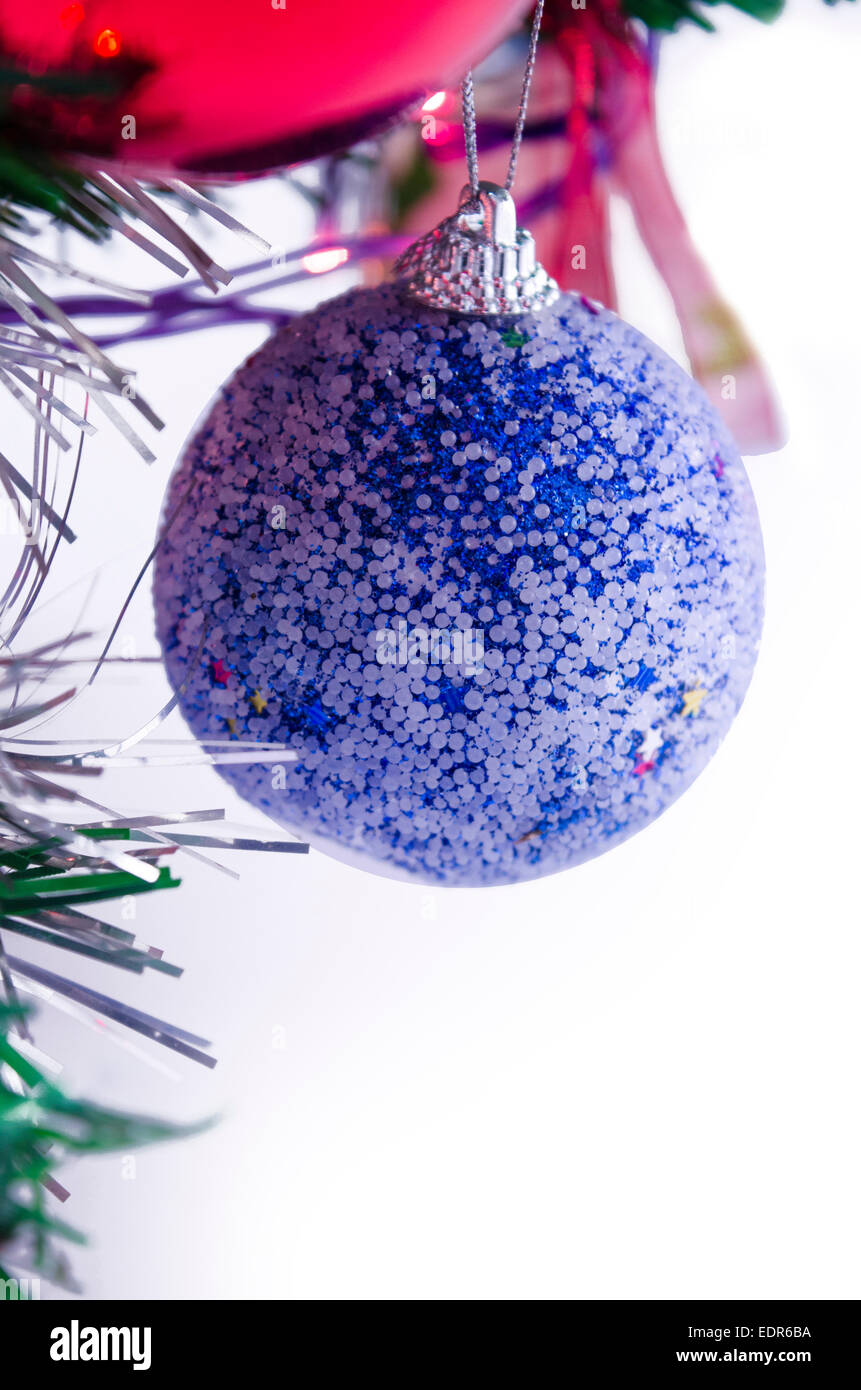 Blue Christmas decoration sphere with tinsels hanging from a Christmas tree Stock Photo