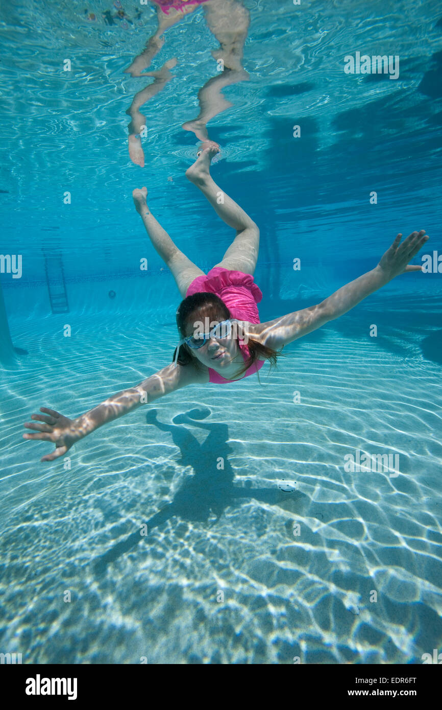 girl swimming toward camera underwater in pool Stock Photo ...