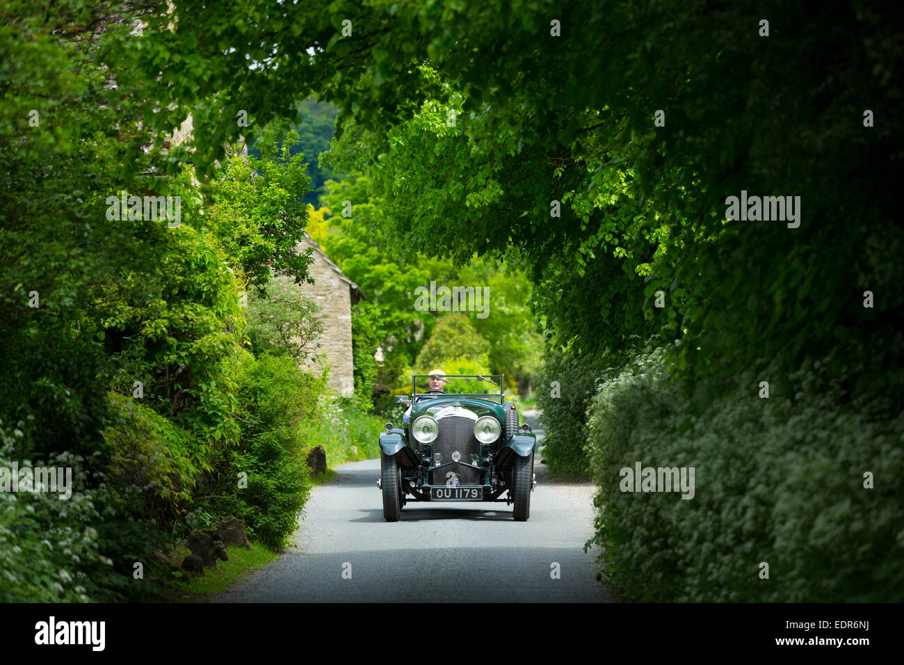 Vintage Bentley 4.5 litres car built in 1929 being driven on touring holiday along country lanes in The Cotswolds, UK Stock Photo