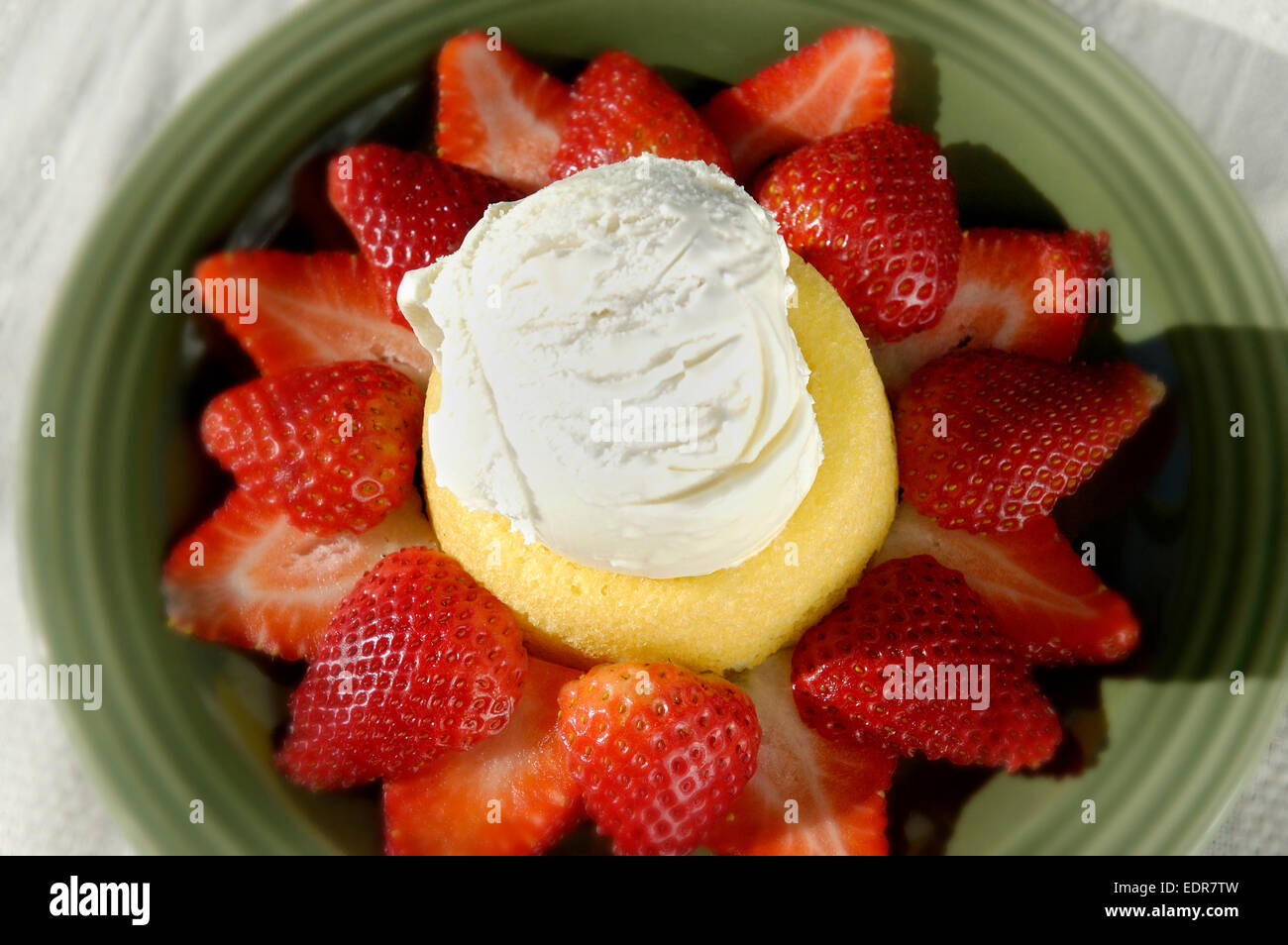 A strawberry shortcake dessert topped with ice cream Stock Photo