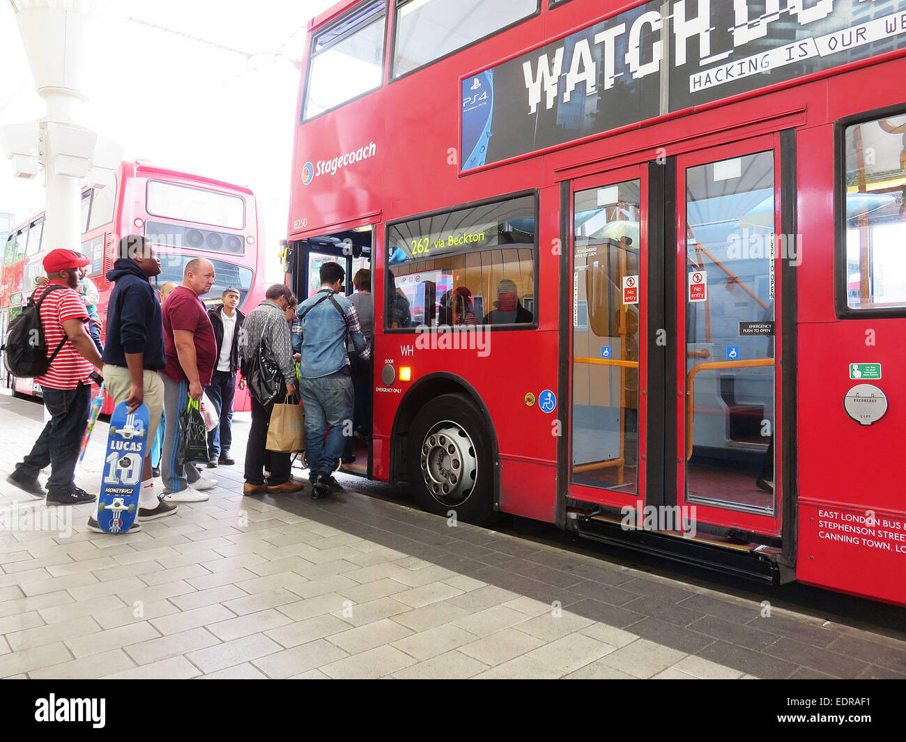 Members of the public in London queue to get on a bus on the first