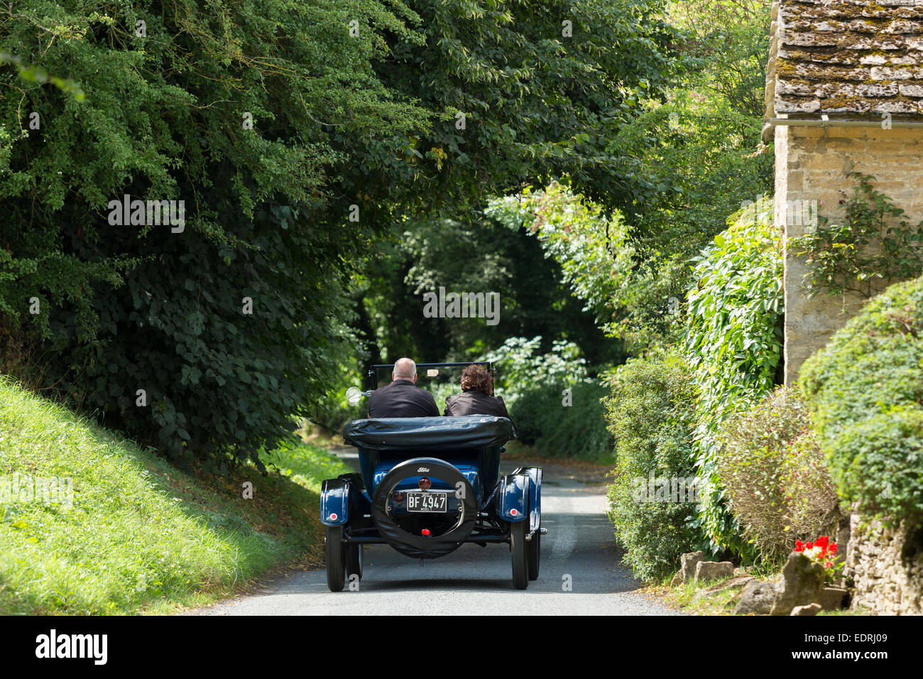 Well-preserved veteran Model T Ford auto touring along country lane in The Cotswolds, UK Stock Photo