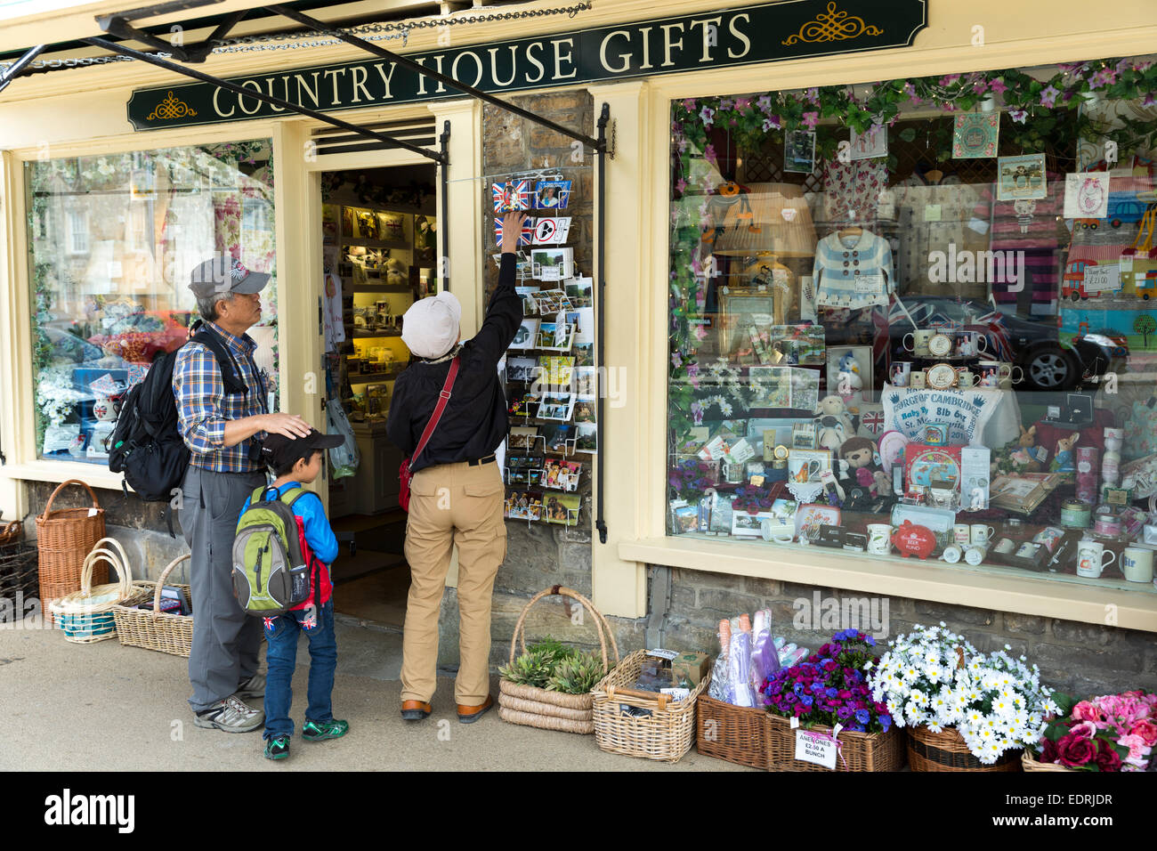 Tourists buying postcards from souvenirs and gifts shop in Burford in
