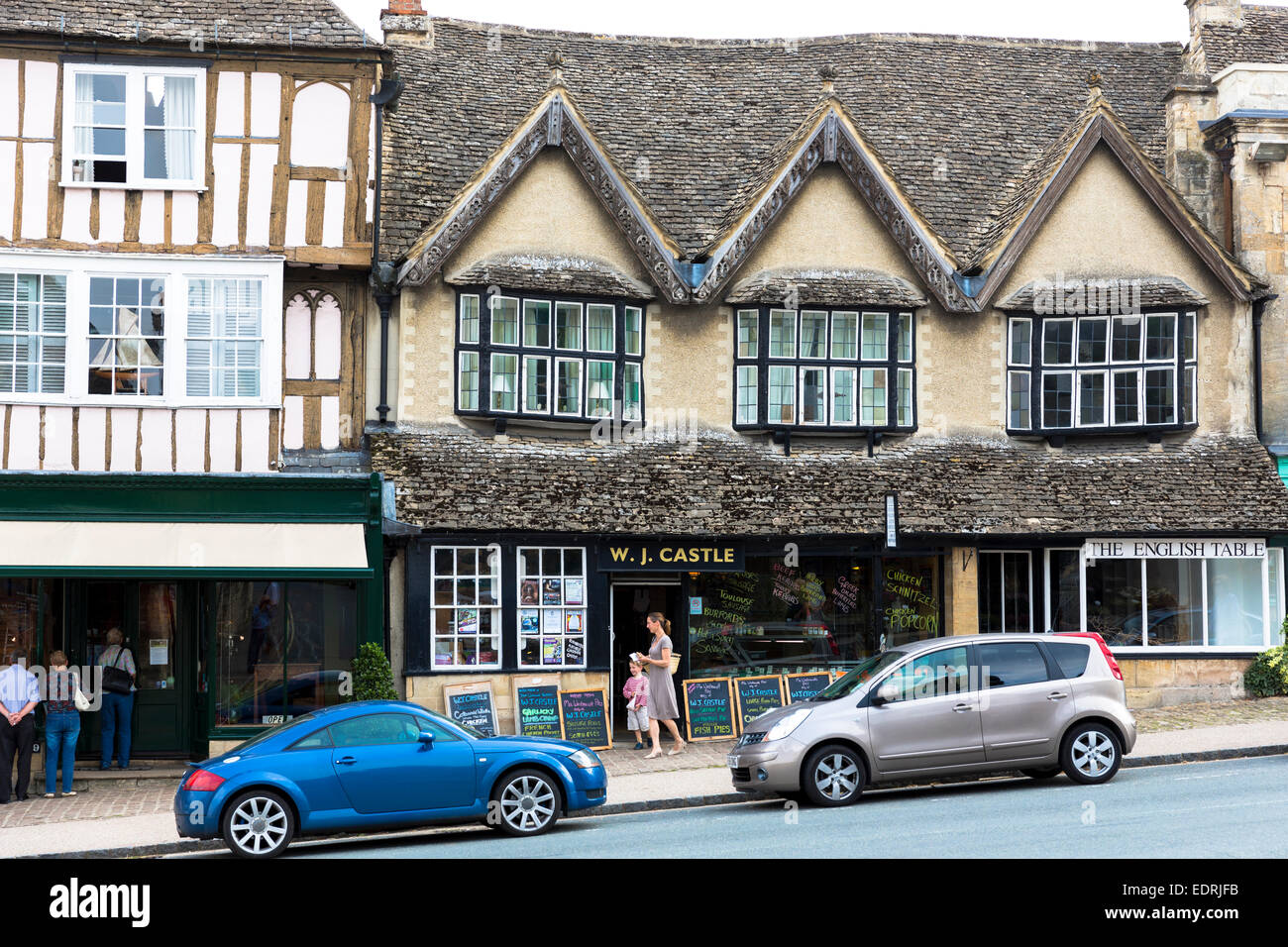 Quaint butcher and cheese shop, medieval and Tudor architecture in famous Burford High Street, The Cotswolds, Oxfordshire, UK Stock Photo