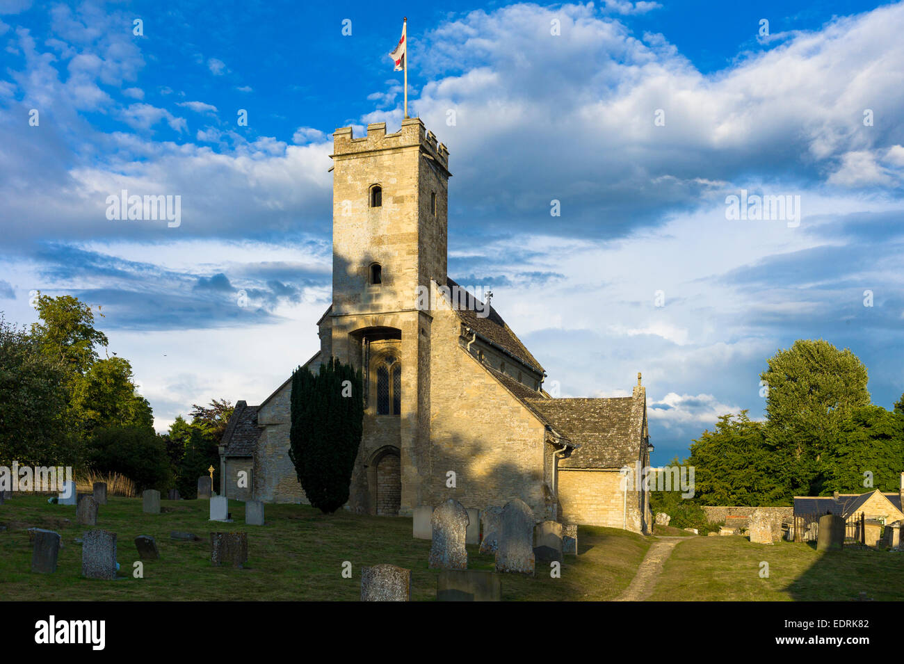 English flag of St George on old stone tower of St Mary's Church, Swinbrook, The Cotswolds, England, UK Stock Photo