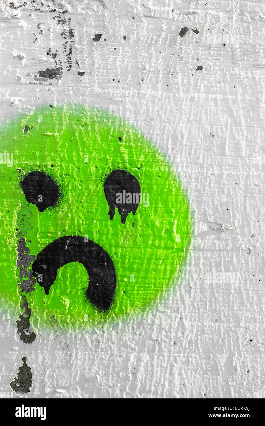 Sadness and tears represented in a graffiti on the wall. Stock Photo