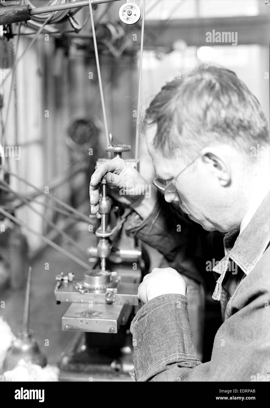 Lancaster, Pennsylvania - Hamilton Watch. Damaskeening - skilled machine operation for putting finishing lines on plates Stock Photo