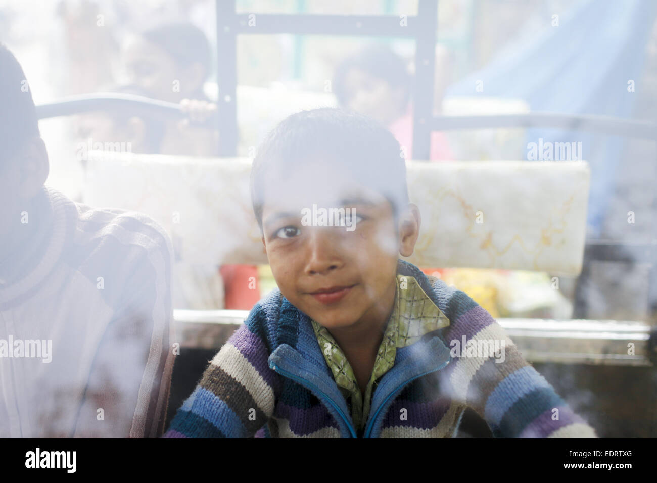 Tongi, Bangladesh. 09th Jan, 2015. th Jan, 2015. 09th Jan, 2014. Dhaka, Bangladesh ''“ A boy play in a broken taxi car in the road side of Bishaw Isema. Muslim devotees who participate at Biswa Istema, the second largest religious gathering of Muslims in the world, in Tongi 20 km from Dhaka city, Bangladesh. The three day long Biswa Istema starts on 09 January where 3 million people will participate from home and abroad. © K M Asad/ZUMA Wire/ZUMAPRESS.com/Alamy Live News Credit:  ZUMA Press, Inc./Alamy Live News Stock Photo