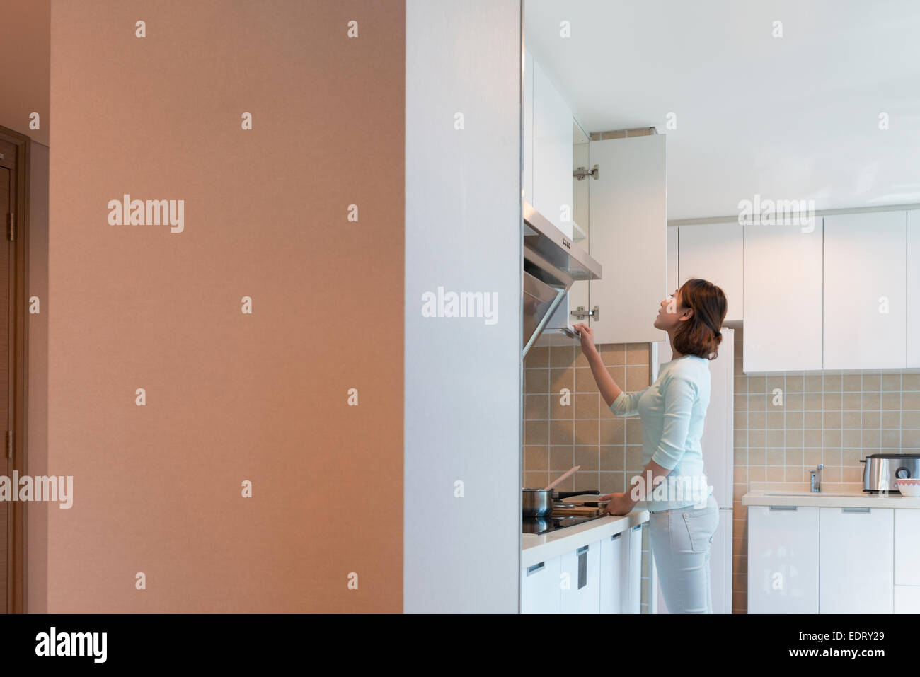 Young woman looking in in kitchen Stock Photo Alamy