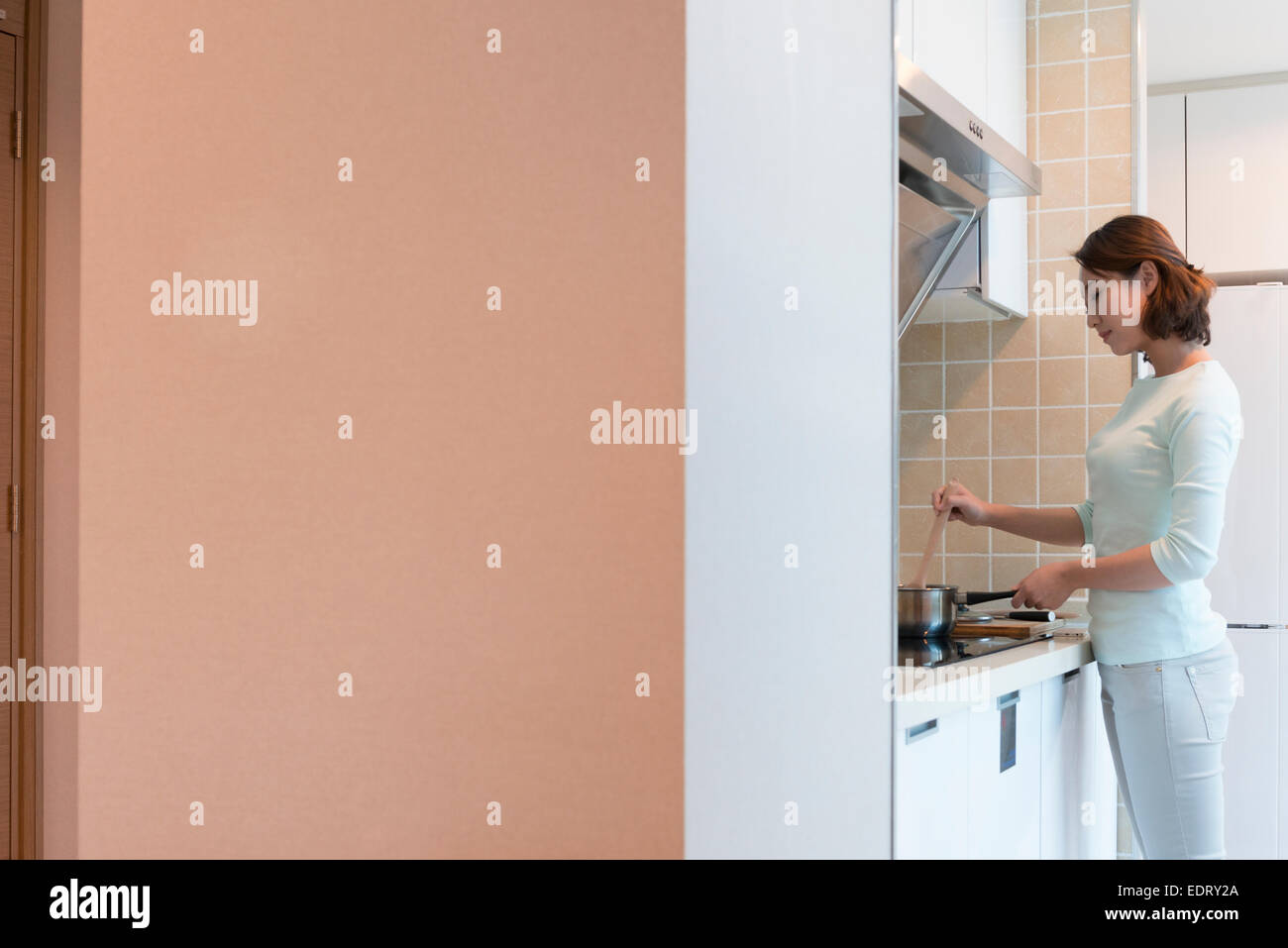Beautiful woman cooking in hi-res stock photography and images - Alamy