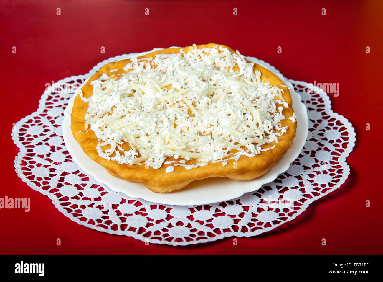 Grilled bun with mozzarella cheese on a red background Stock Photo