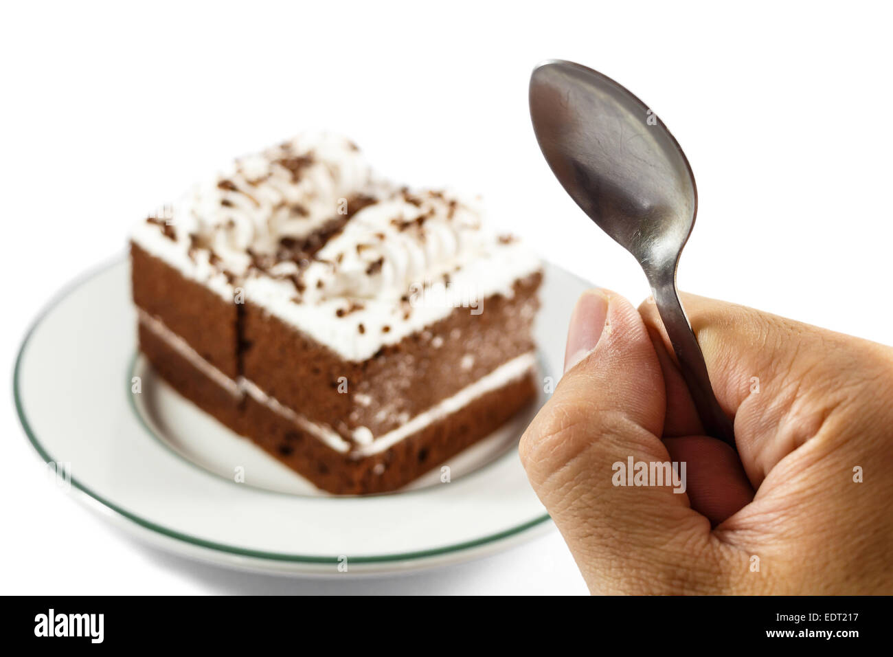 person hold spoon and chocolate cakes on white background Stock Photo