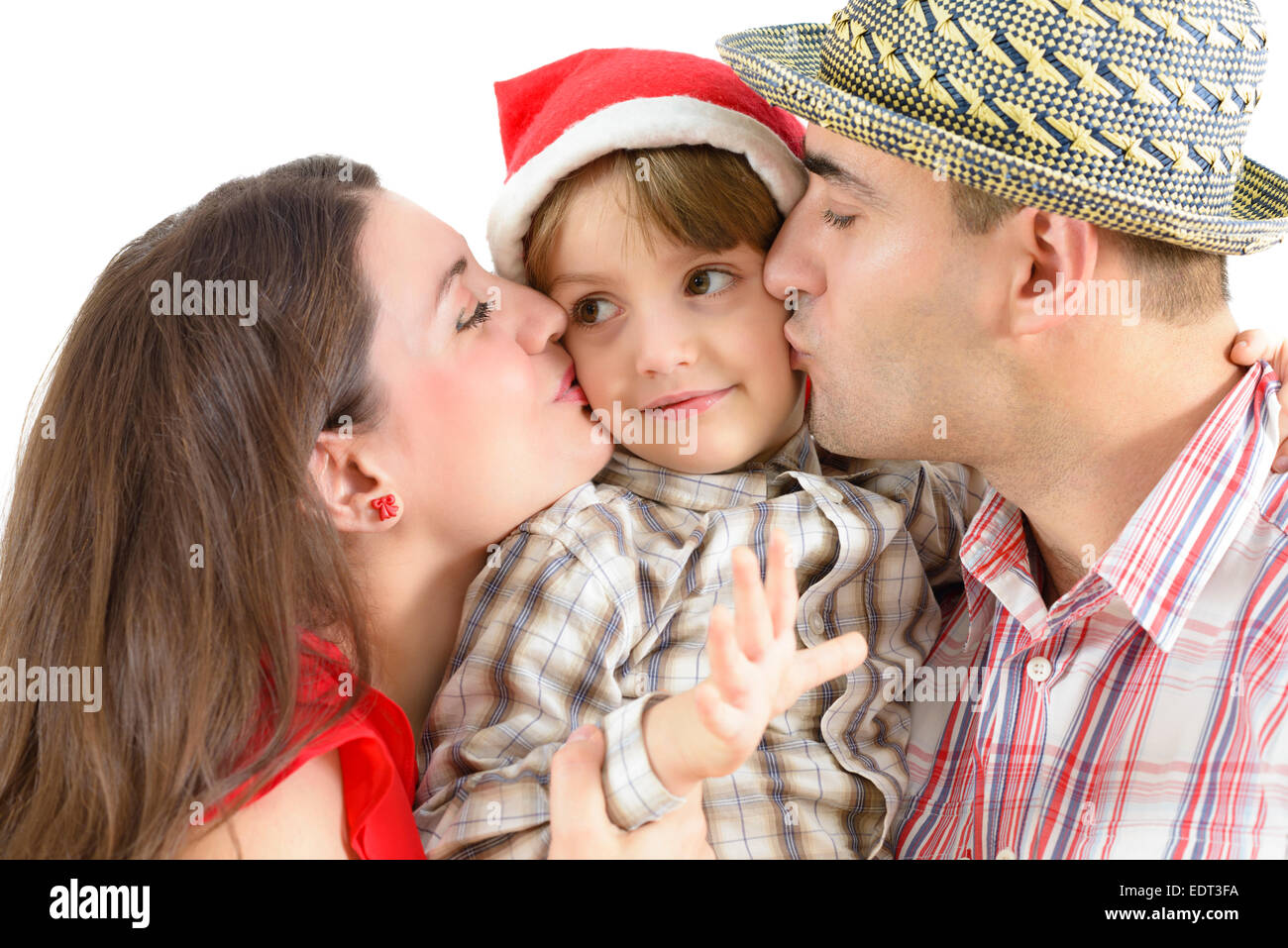 Mom and dad kissing their little boy Stock Photo