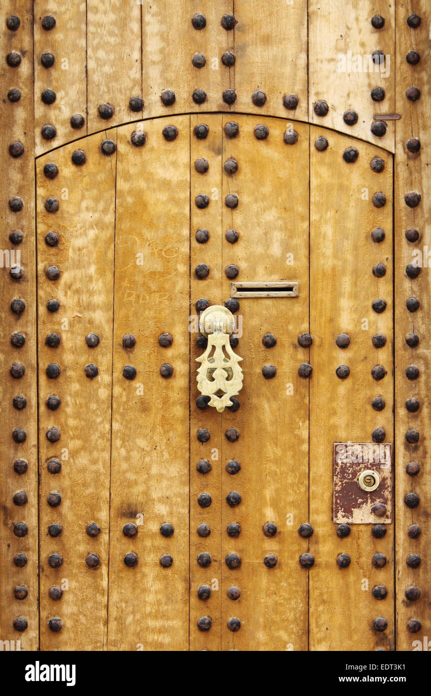 Wooden door with arab style doorknob in Marrakech, Morocco Stock Photo