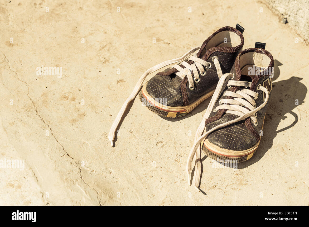 Kid's old canvas shoes in front of rural house ,Thailand Stock Photo