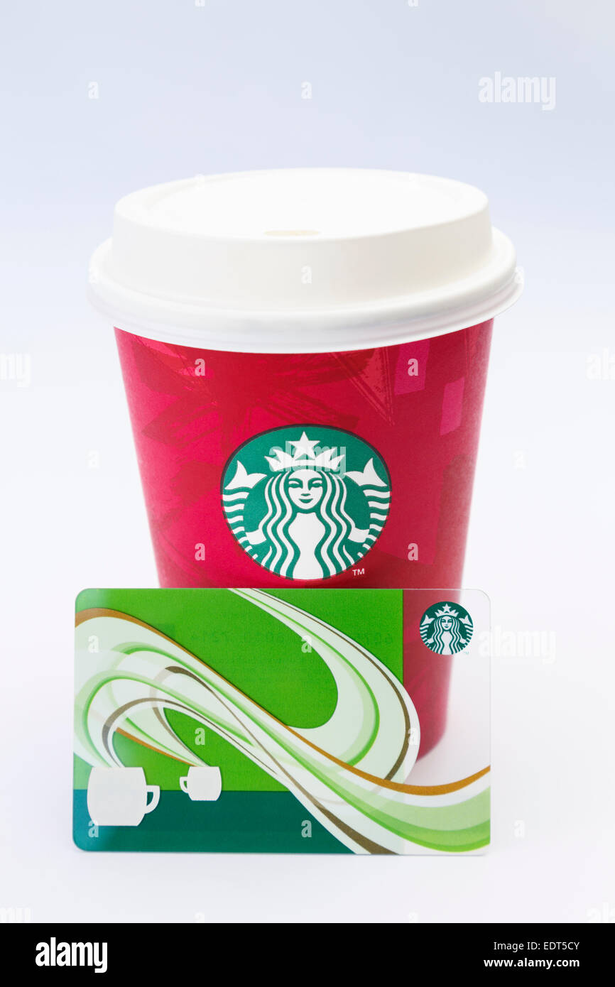 Starbucks disposable take-away paper coffee cup in festive red with plastic drink-through lid and loyalty points card. UK Stock Photo