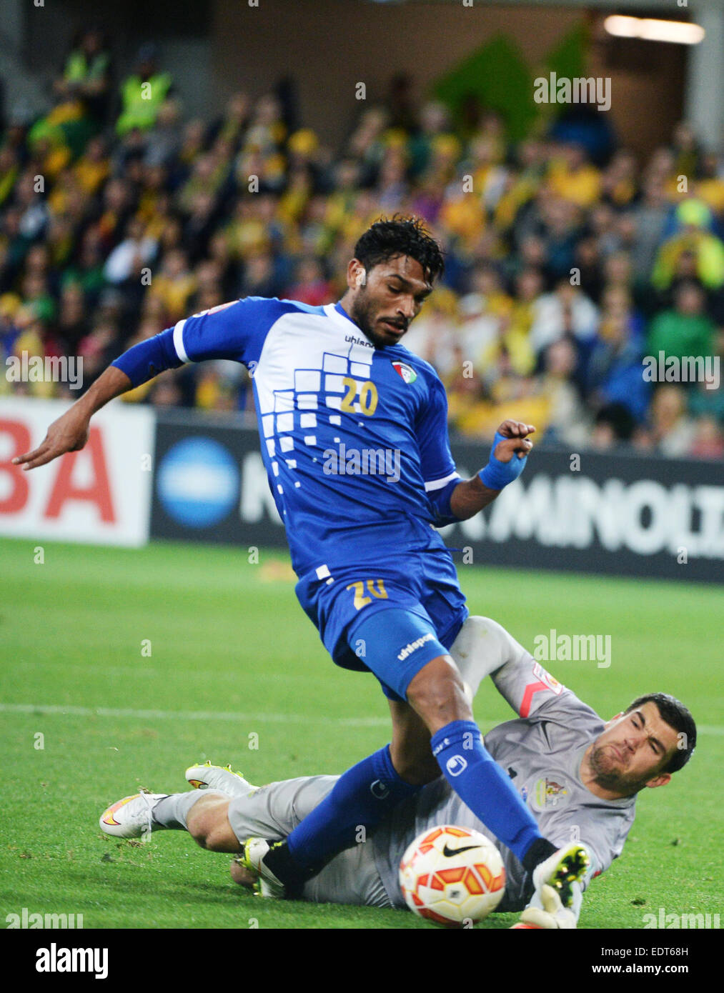 Melbourne, Australia. 9th Jan, 2015. Yousef Naser Alsulaiman (top) of Kuwait vies with Mathew Ryan of Australia during the opening football match at the AFC Asian Cup in Melbourne, Australia, January 9, 2015. Australia won 4-1. Credit:  Qin Qing/Xinhua/Alamy Live News Stock Photo