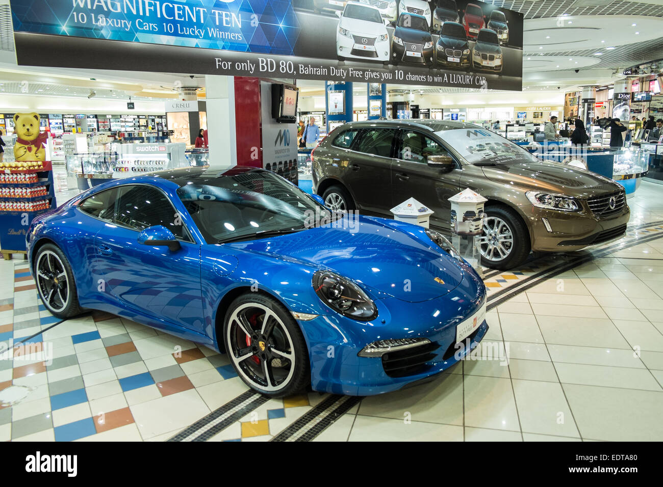 Lottery at Duty Free for blue Porsche and brown Volvo cars Bahrain International Airport, Bahrain, Middle East Stock Photo