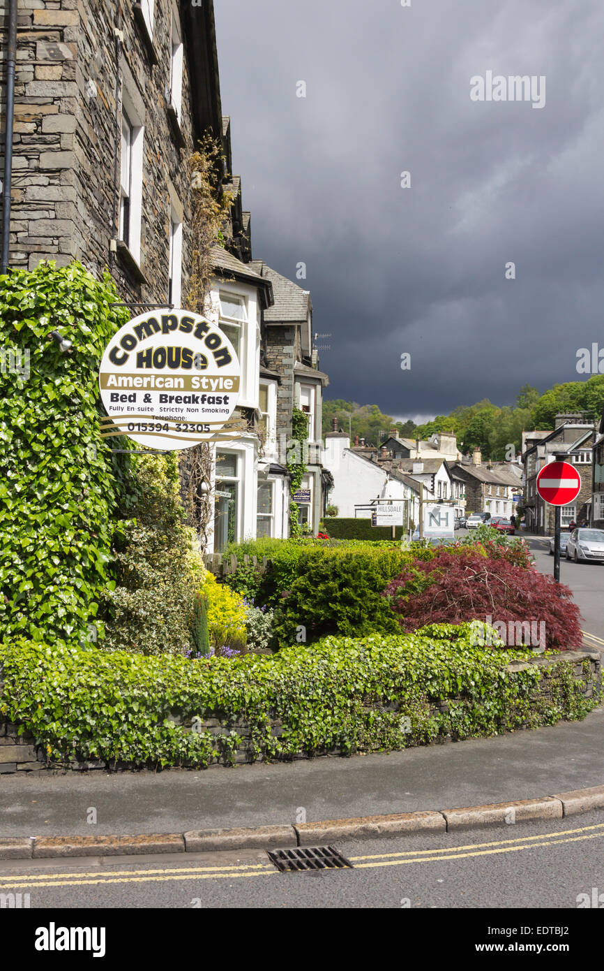 Lake District Guest Houses in Ambleside, Cumbria. Dark clouds threaten rain over the fells beyond the town. Stock Photo