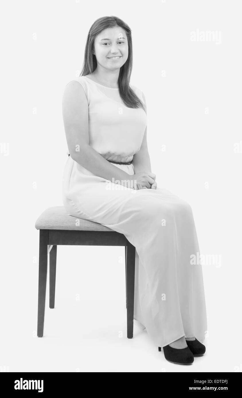 Teenager girl sitting in chair on white background Stock Photo - Alamy