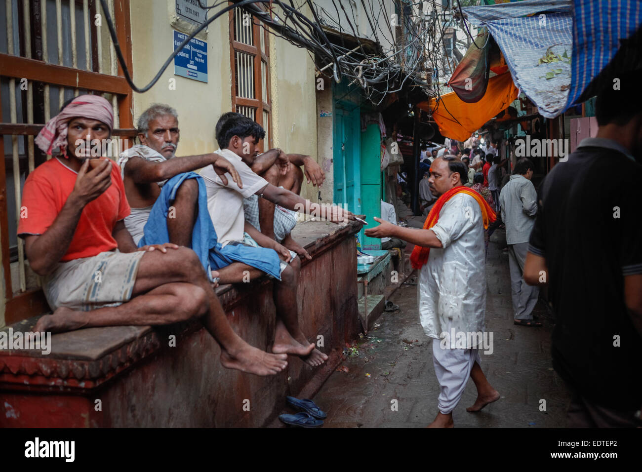 Men enjoying leisure time at an alley in Varanasi, India. Stock Photo