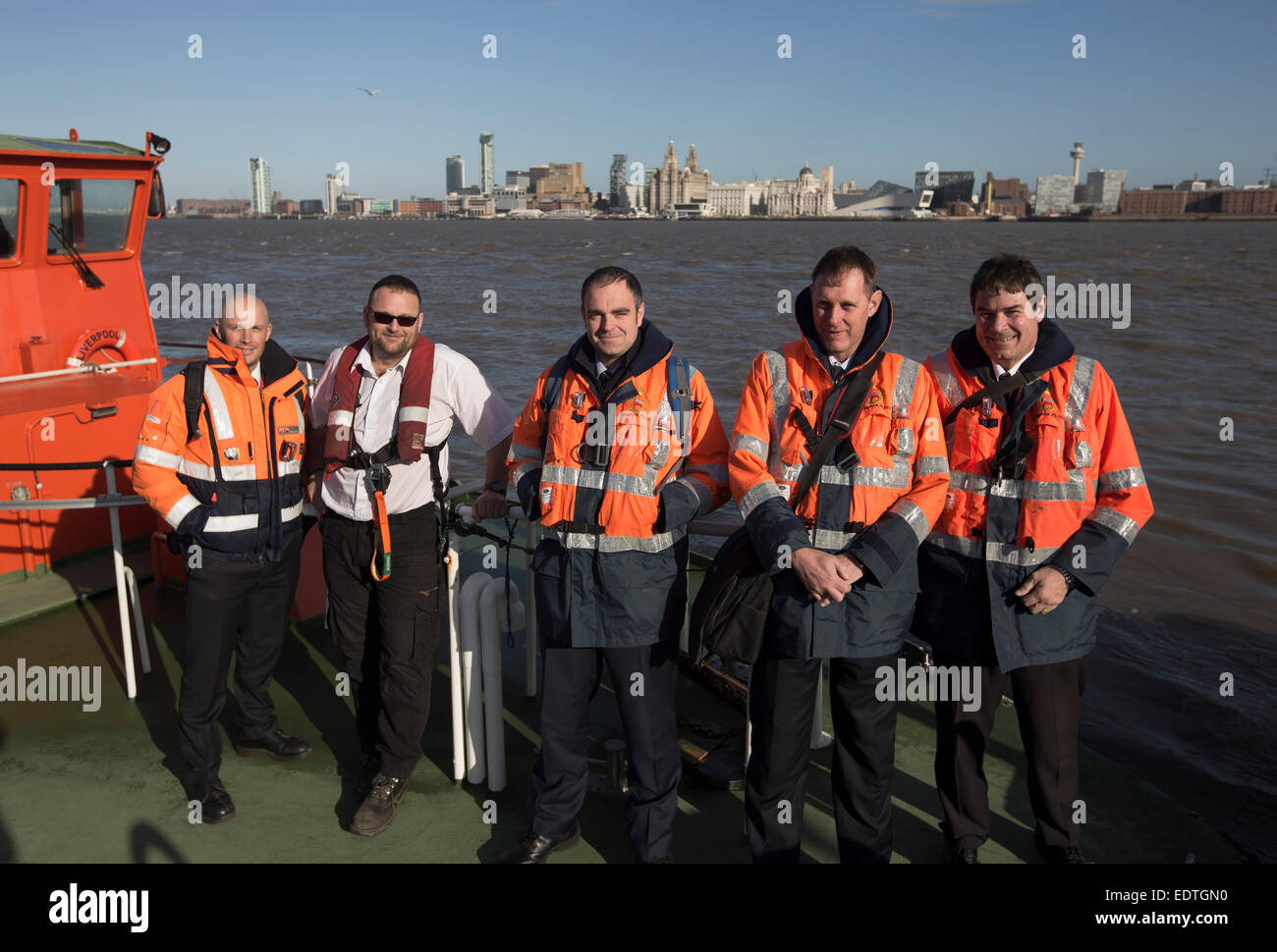 A team of Liverpool pilots employed by Liverpool Pilot Services Ltd on the river Mersey, England, on board a pilot launch. Stock Photo