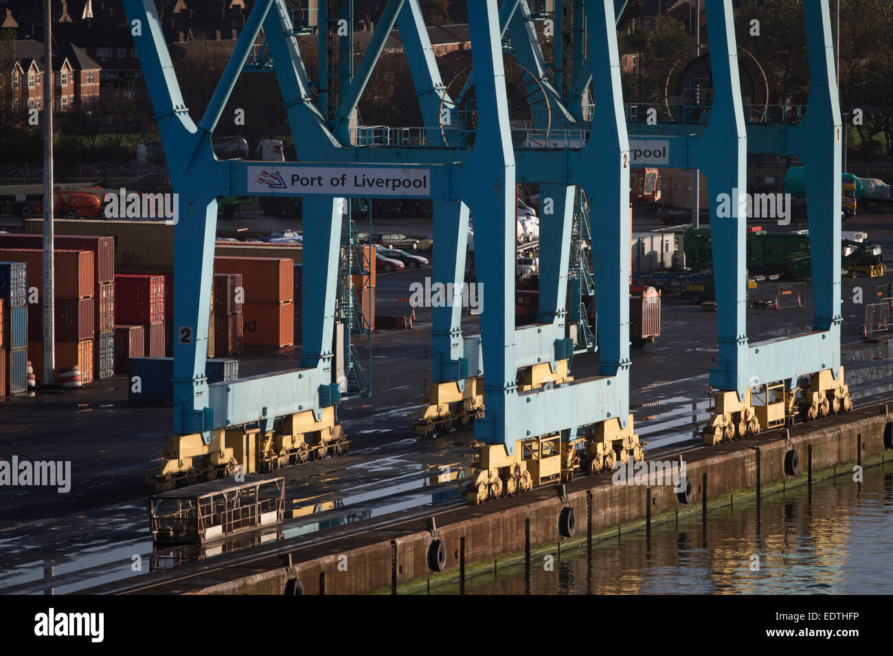 Cargo containers and a crane on the dock side at Seaforth Docks, Liverpool, England, UK. Stock Photo