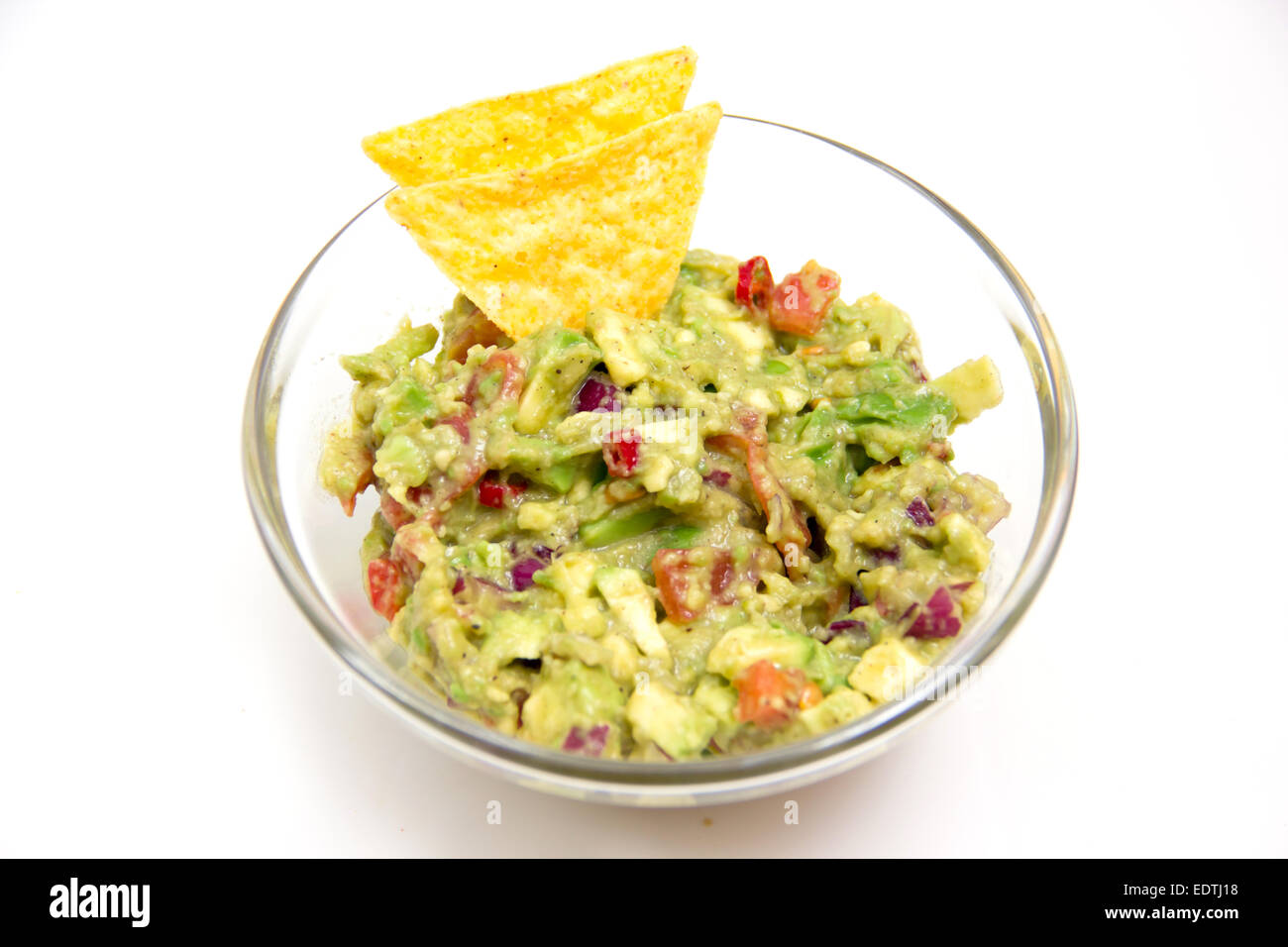 Guacamole in glass bowl on white background Stock Photo