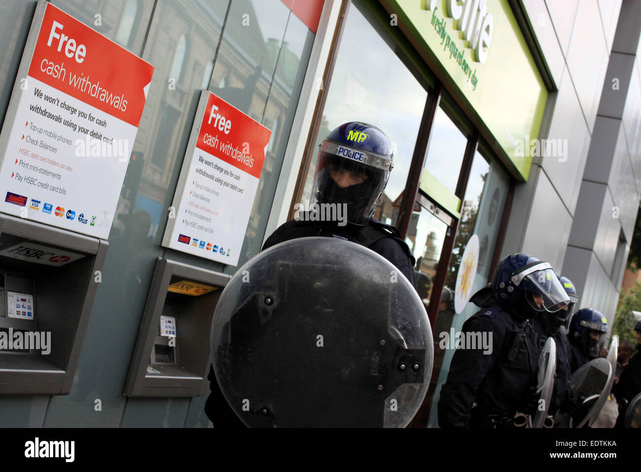Riot police guarding a bank and shops in Hackney during the 2011 riots Stock Photo