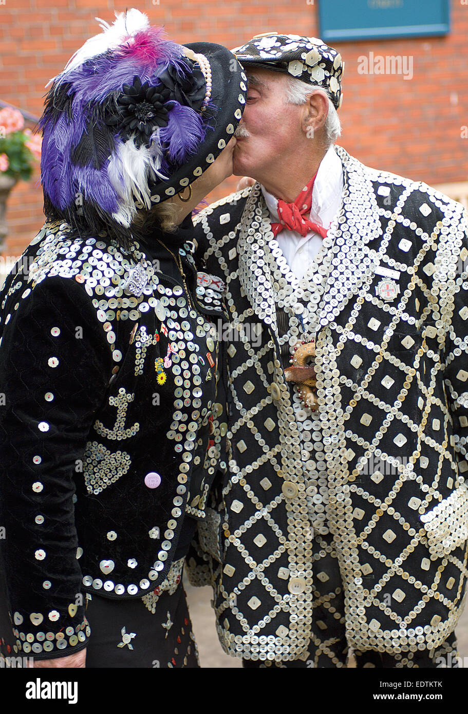 A Pearly King and Queen kiss each other before the Harvest Festival service.at St. Paul's Church, Covent Garden. Stock Photo