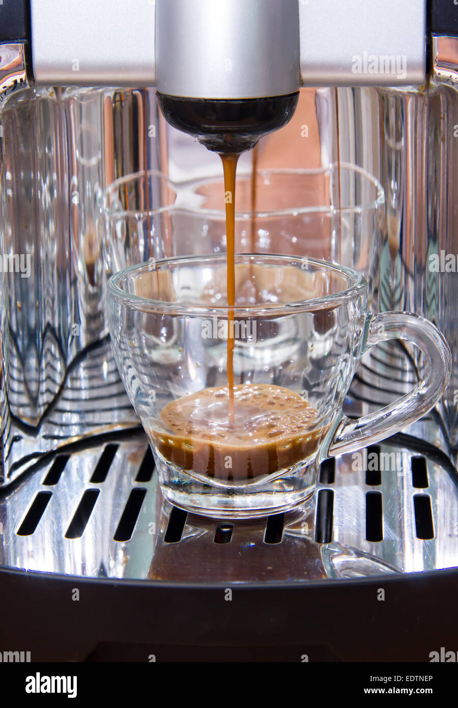 Espresso coffee machine makes coffee while Stock Photo Alamy