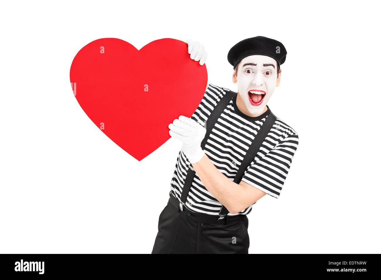 Mime artist holding a big red heart isolated on white background Stock Photo