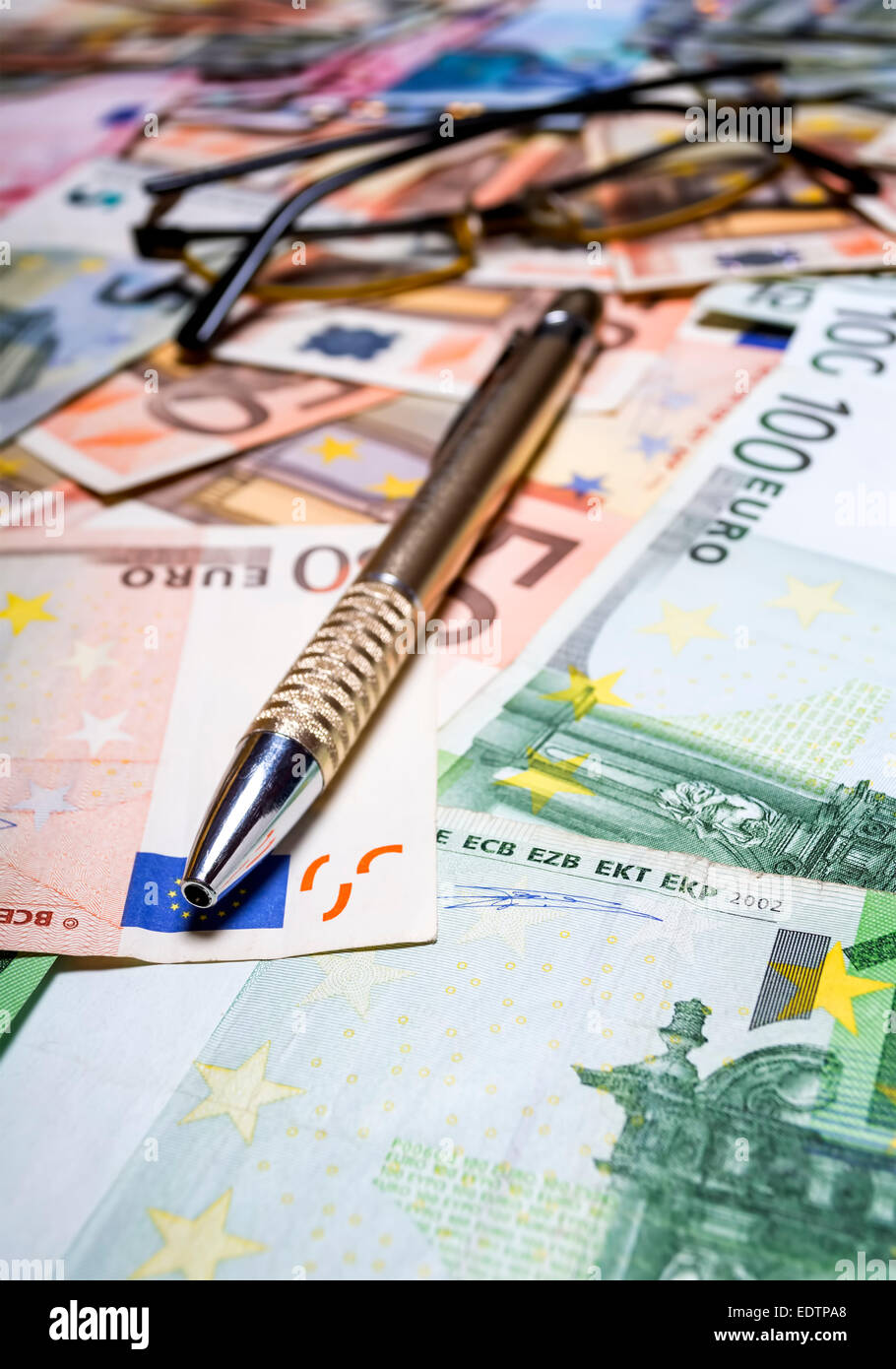 Pen with euro banknotes. Shallow depth of field. Stock Photo