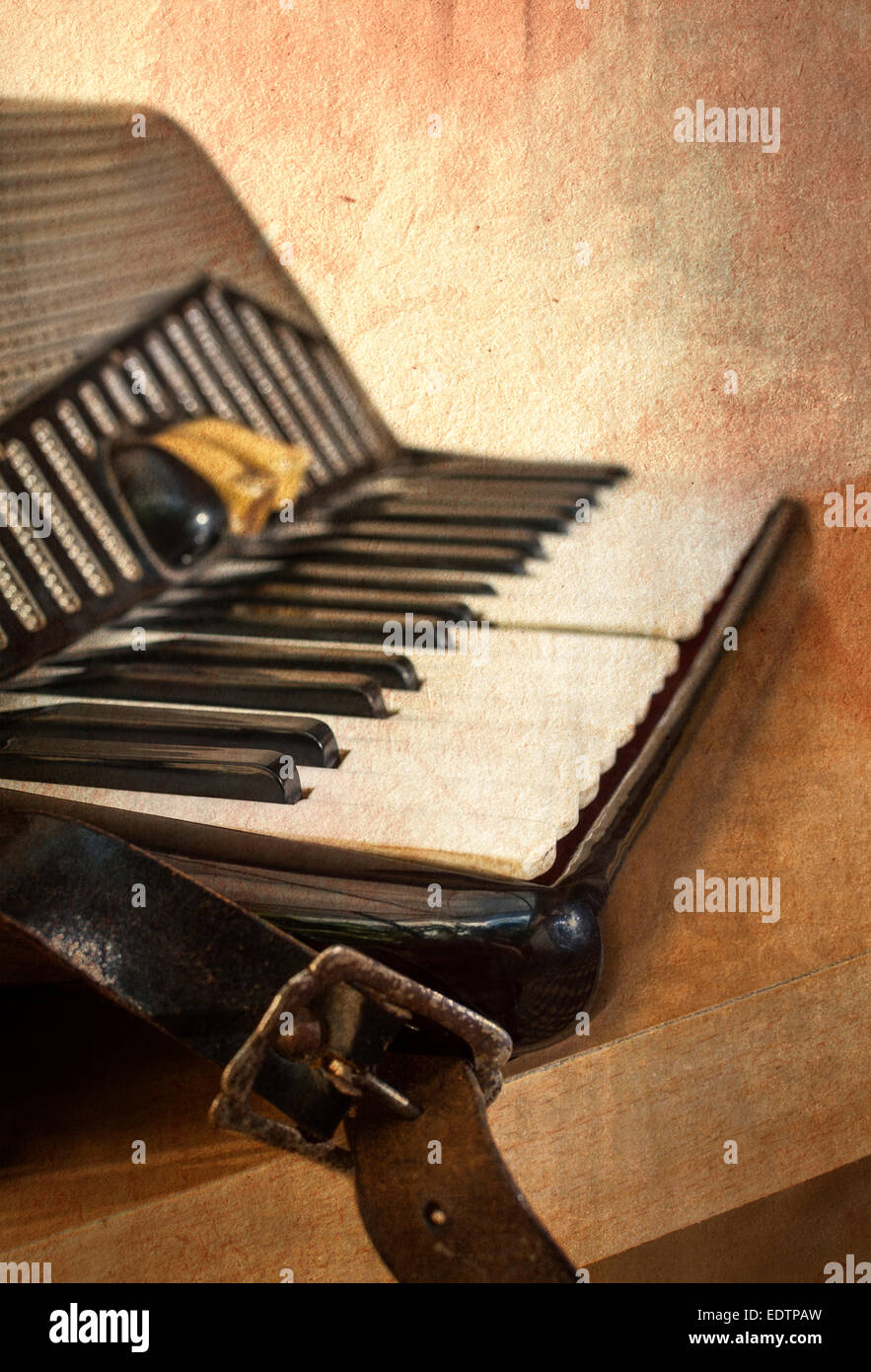 Old accordion instrument in grunge style. Shallow depth of field. Stock Photo