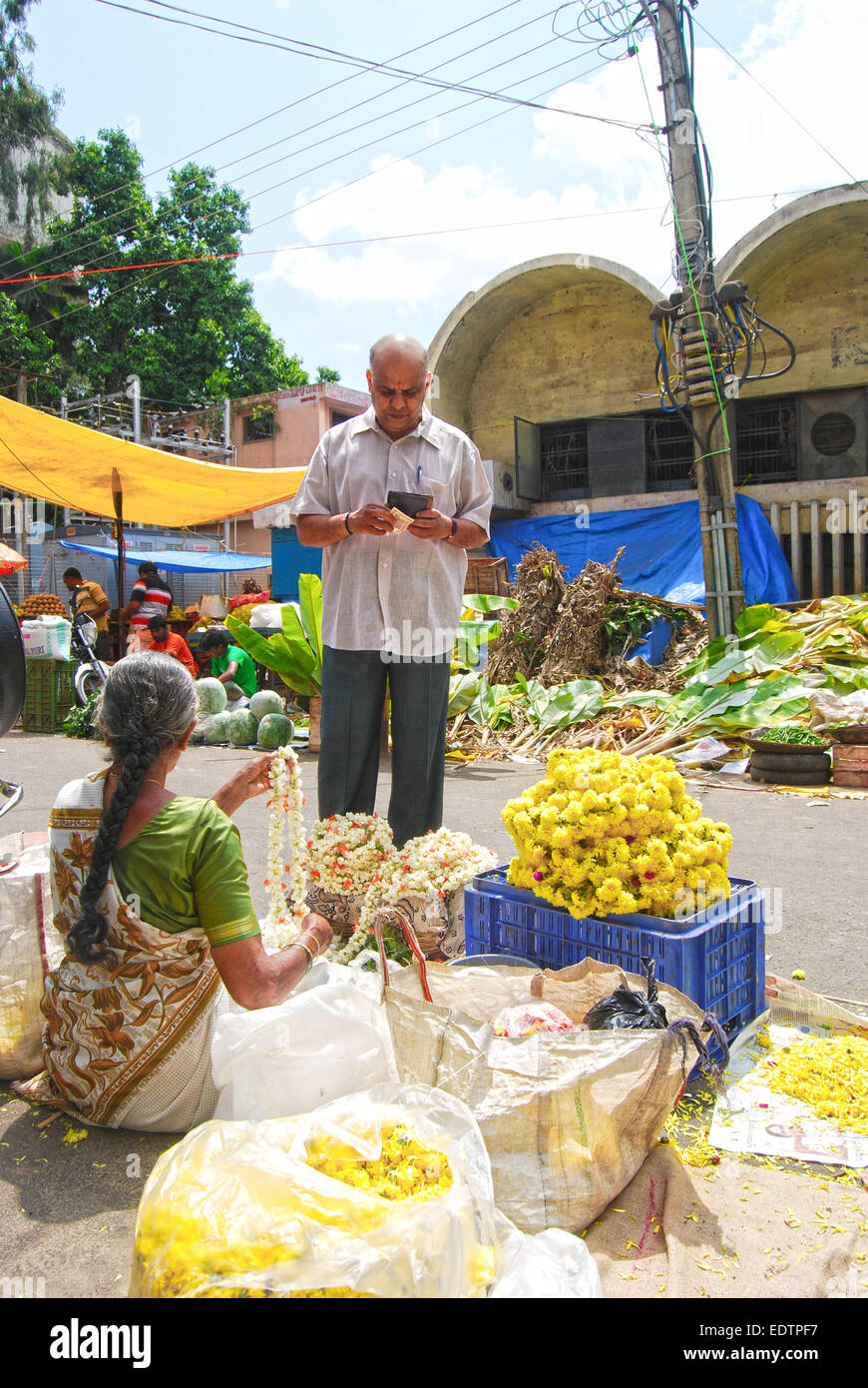 Buyers & sellers in a busy flower market of Bangalore, India. Stock Photo