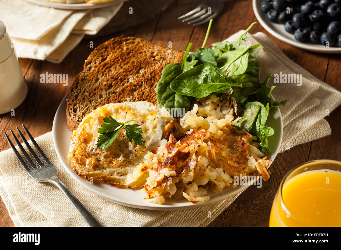 Organic Homemade Fried Eggs with Toast and Hashbrowns Stock Photo