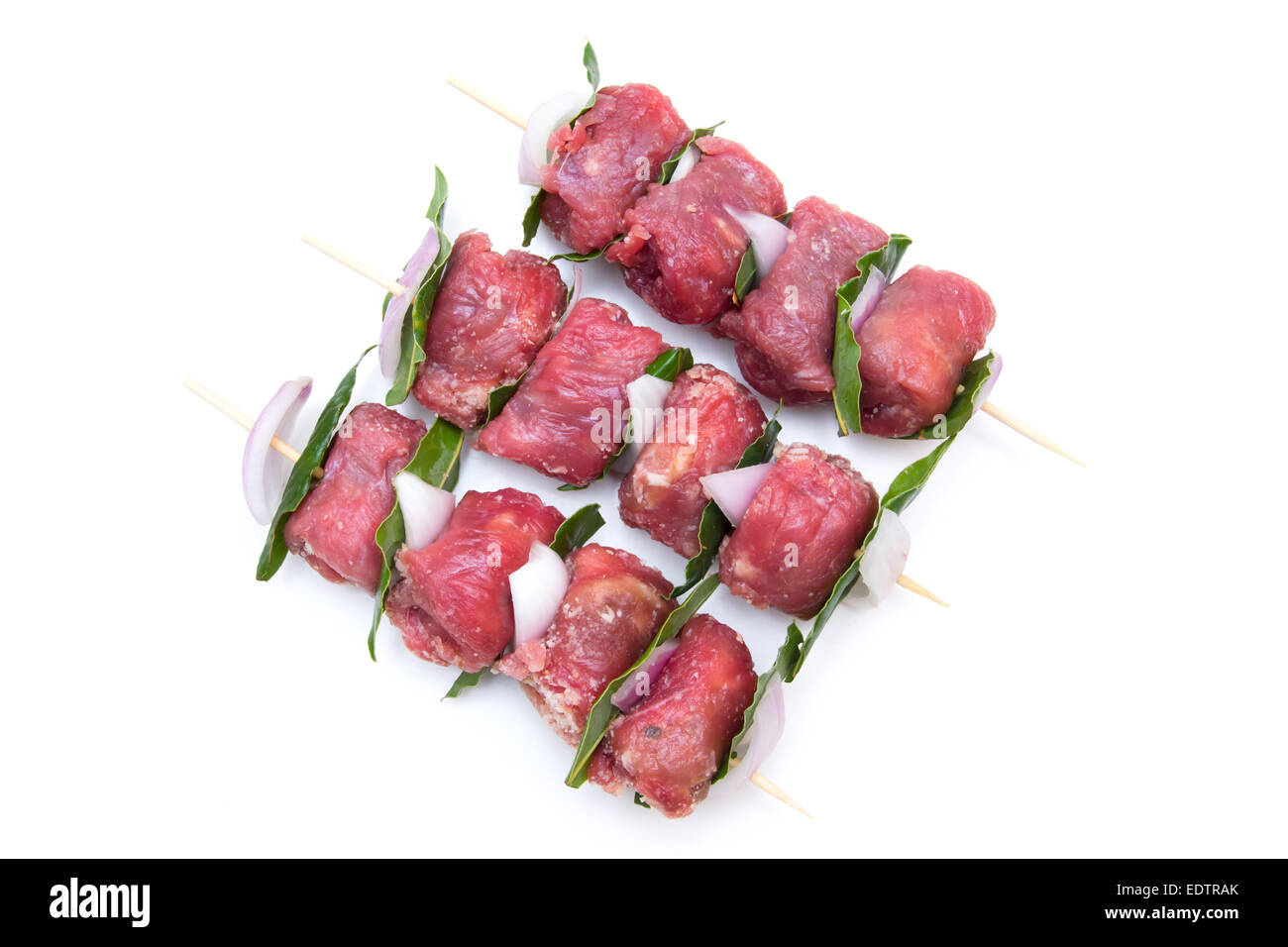 Skewers of meat from above on white background Stock Photo