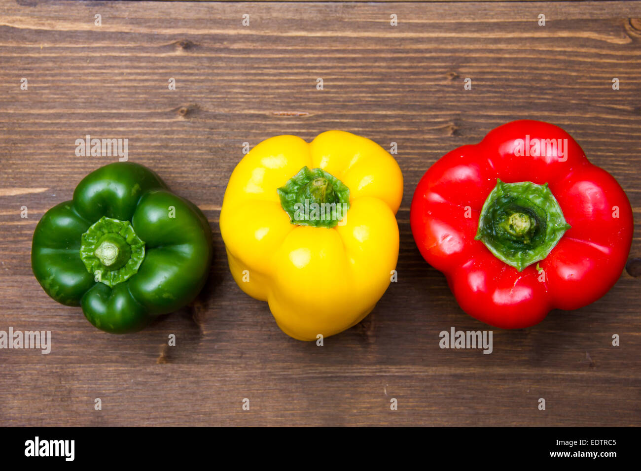 Peppers on wood top Stock Photo - Alamy